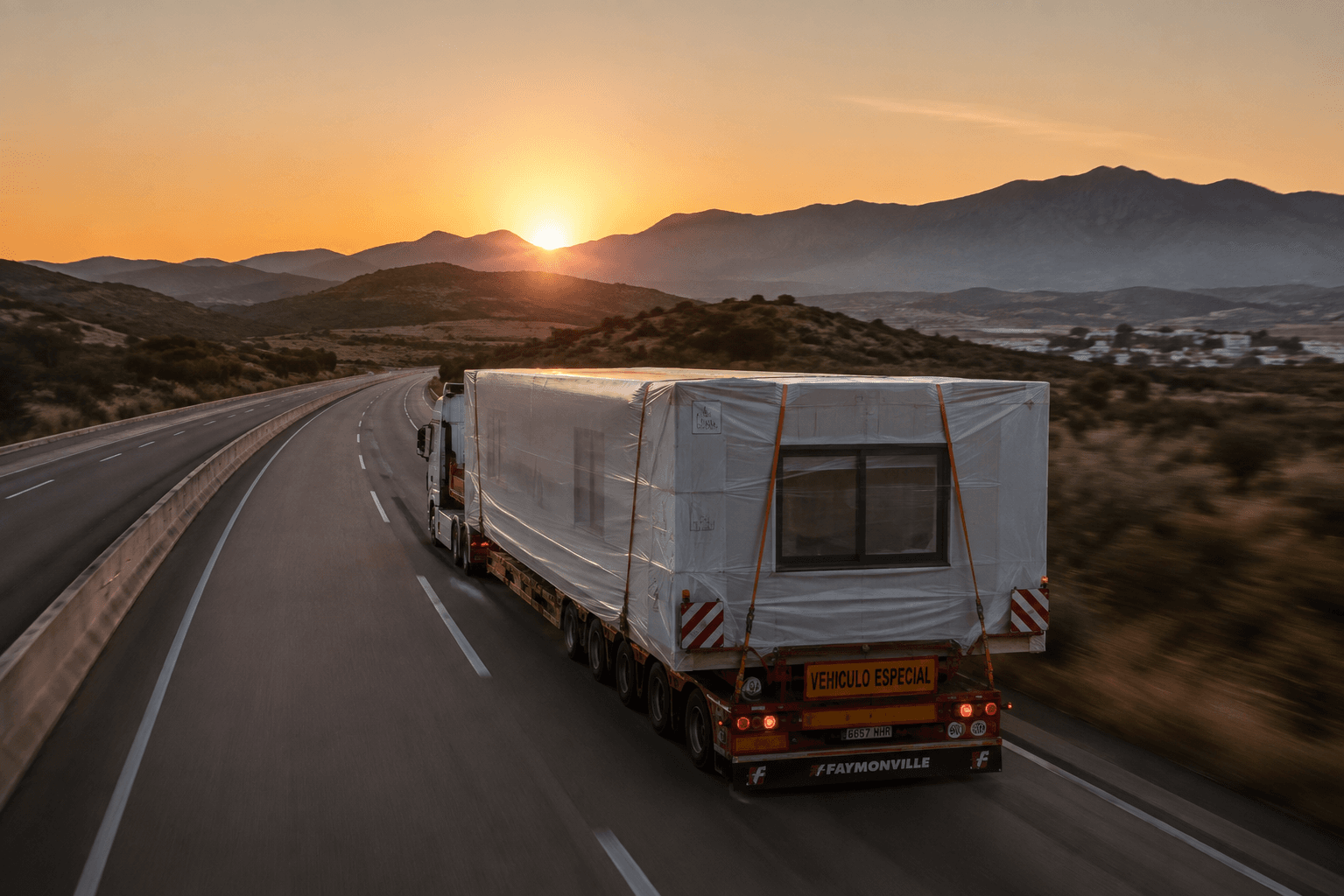 Terra Viva module being transported by truck at sunset